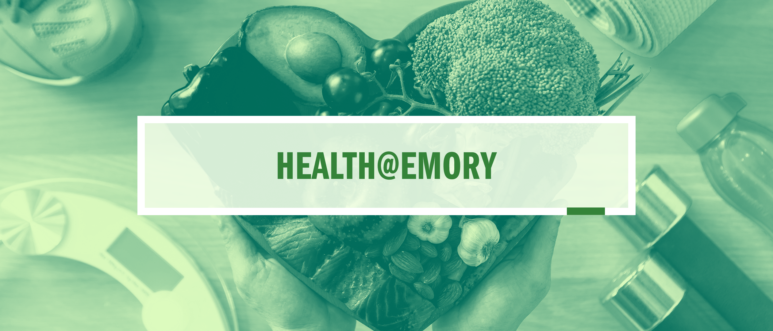 A pale-green image of fruits and vegetables held by two Caucasian hands in a heart shape, with a scale, water bottle and dumbbells in the background. Surmounted by a semi-opaque white box holding the words "Health@Emory"